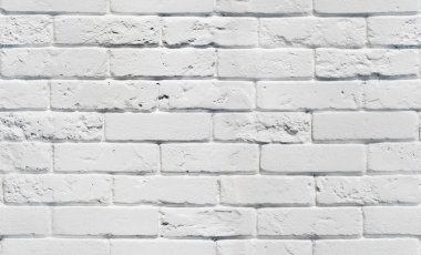 Beyaz tuğla duvar. Kusursuz bir arka plan modeli. Beyaz boyalı tuğlalı, dikişsiz dokular. Kusursuz beyaz arkaplan.
