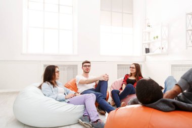 Creative business team sharing ideas for start-up. Smiling optimistic people working on new project at modern office, copy space