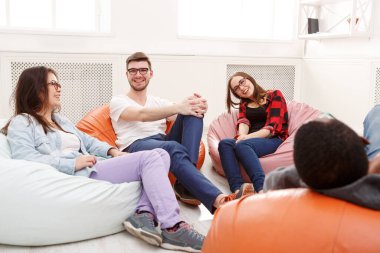 Creative business team sharing ideas for start-up. Laughing people working on new project at modern office