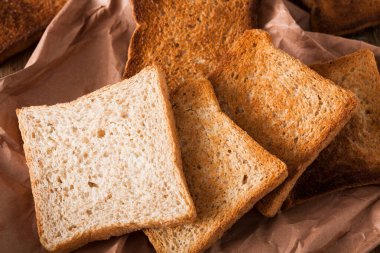 Kraft kağıt ahşap masa üzerinde beyaz ekmek tost dilim. Natürmort, gıda arka plan, portre