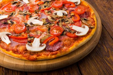 Delicious pizza with mushrooms, peppers and pepperoni