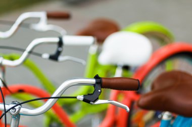 Closeup of bicycle's handlebars and saddles clipart