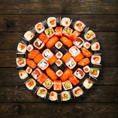 Set of sushi, maki and rolls isolated at wood clipart