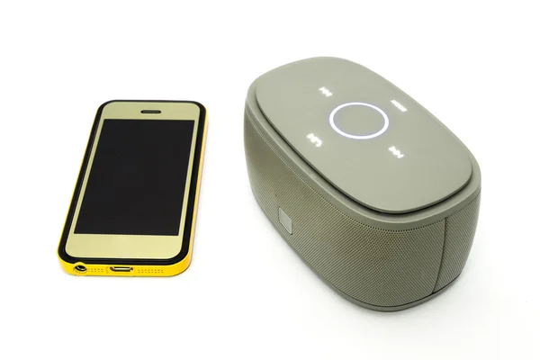 Gold smart phone and bluetooth speaker — Stock Photo, Image