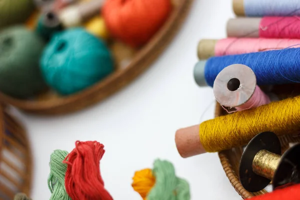 colorful sewing threads, tailoring tools in baskets