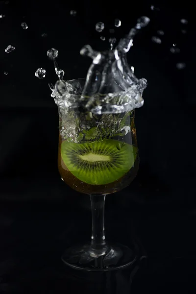 Siyah arka planda su sıçrama Kiwi