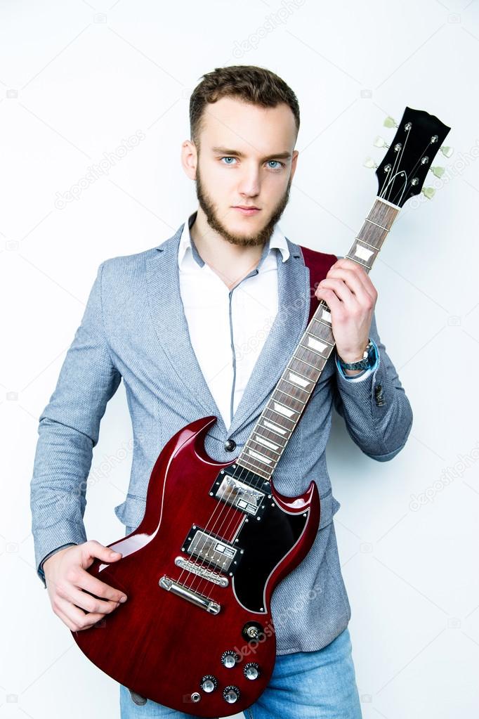Male musician holding electric guitar
