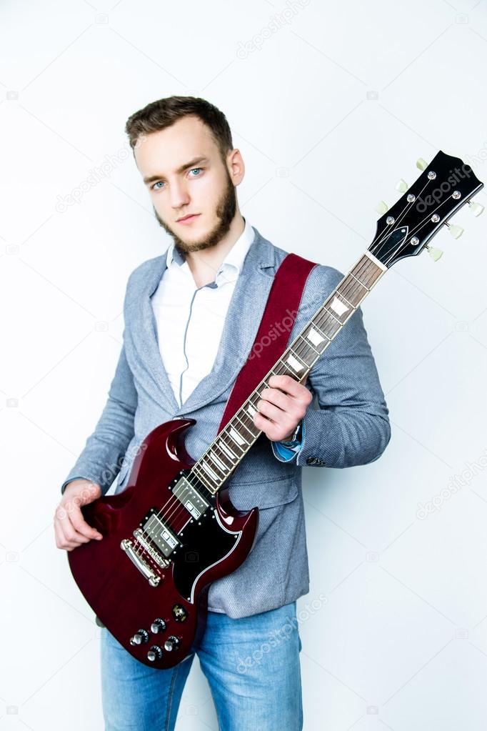 Male musician holding electric guitar