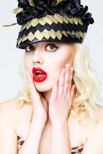 Young blonde woman in extravagant hat — Stock Photo, Image