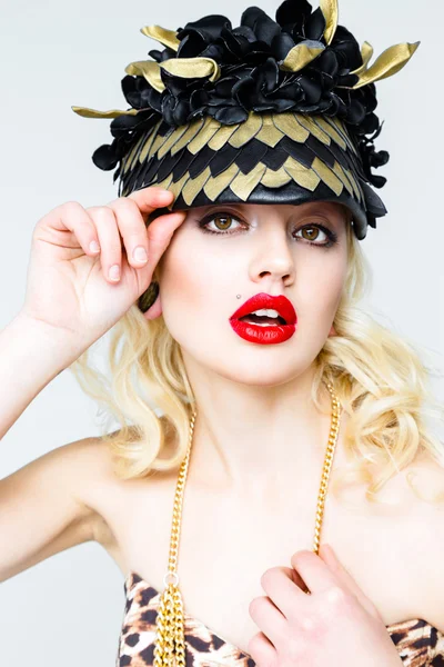 Young blonde woman in extravagant hat — Stock Photo, Image