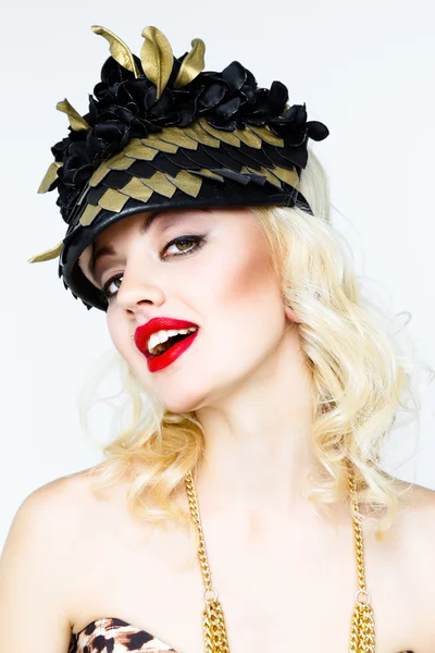 Young blonde woman in extravagant hat — Stock Photo, Image