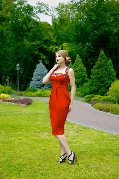 Attractive young woman in red dress — Stock Photo, Image