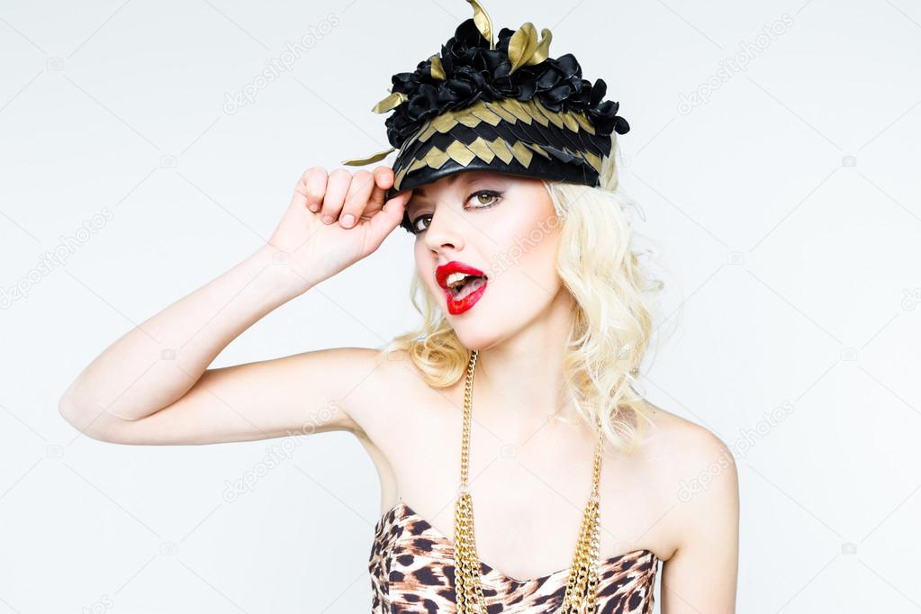 Young blonde woman in extravagant hat