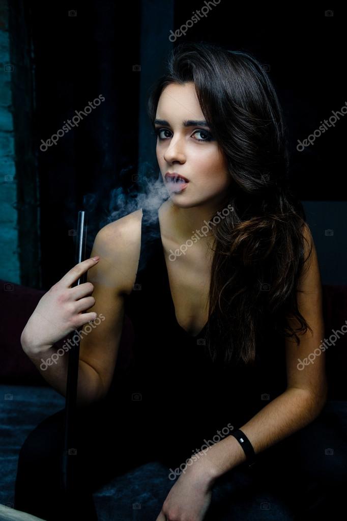 Woman smokes a hookah — Stock Photo © smmartynenko 103095770