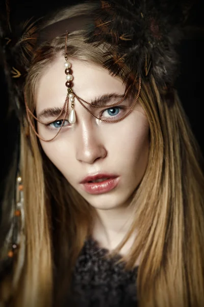 Woman with feather in hair — Stock Photo, Image