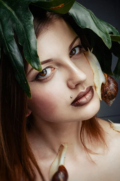 Attractive female posing with snails — Stock Photo, Image