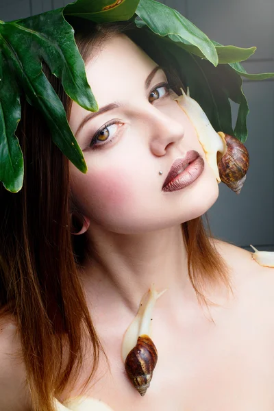 Attractive female posing with snails — Stock Photo, Image