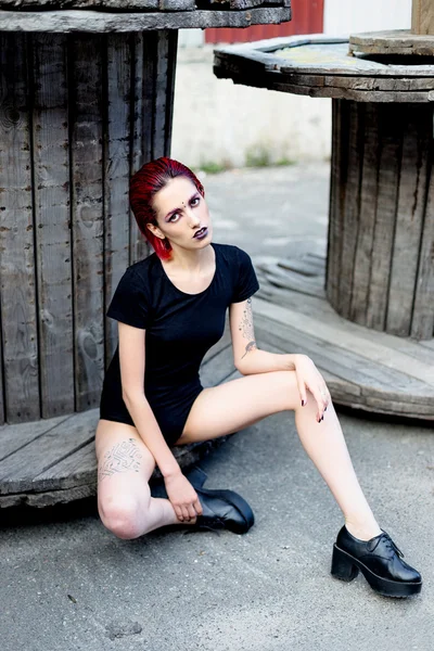 Attractive young woman on wooden reels — Stok fotoğraf