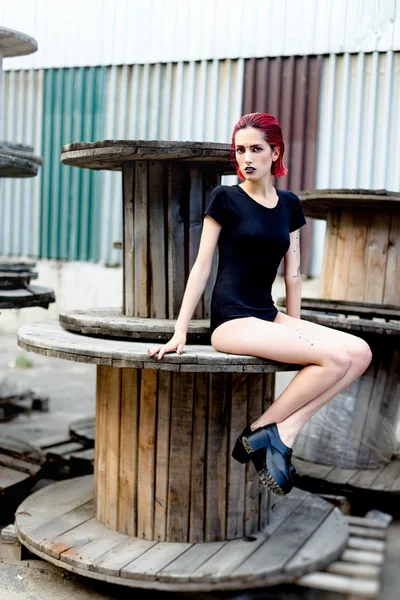 Attractive young woman on wooden reels — Stok fotoğraf