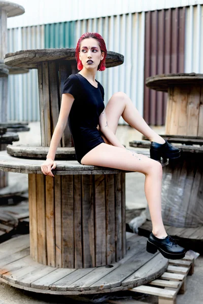 Attractive young woman on wooden reels — Stock Fotó