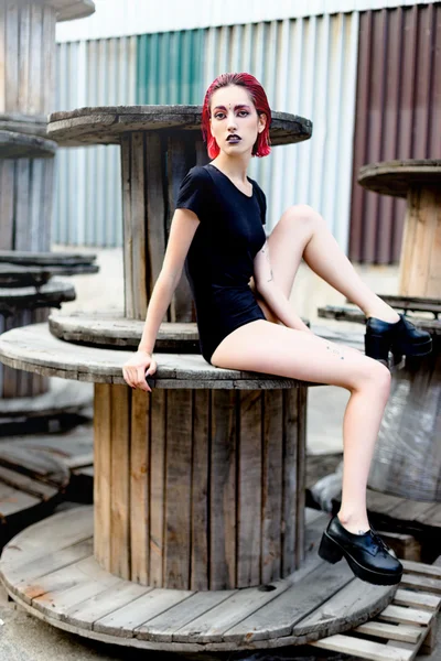 Attractive young woman on wooden reels — Stok fotoğraf