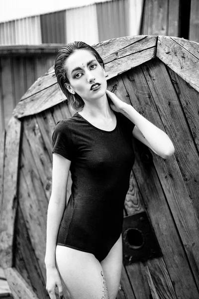 Attractive young woman in black bodywear — Stock fotografie