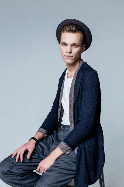 Young man sitting on chair — Stock Photo, Image