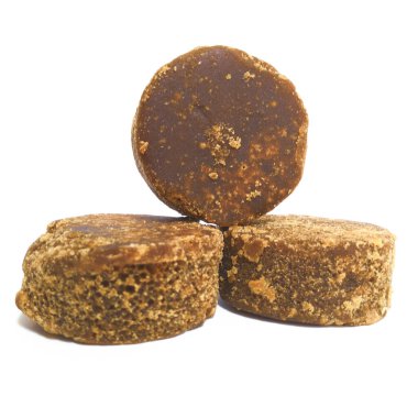 Beyaz zemin üzerinde 3 kahverengi şeker (gula merah) izole