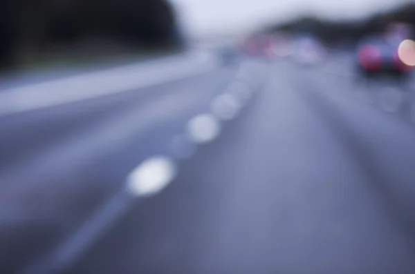 Abstract blurred car dangerous highway driving on wet rainy and foggy day. Rainy and foggy conditions on the highway. Motion blur visualizes the speed and dynamics. — Stock Photo, Image