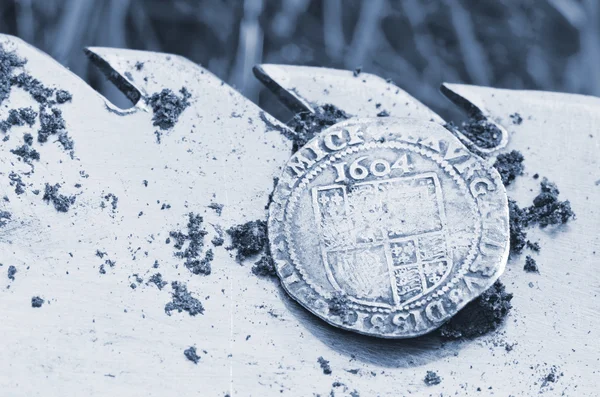 Antigua moneda de plata martillada expuesta en una pala, encontrada en la vida excavada por un detector de metales . — Foto de Stock