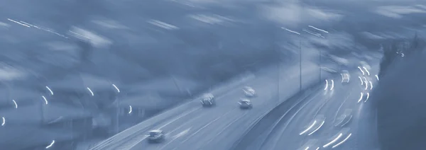 Abstract blurred car dangerous highway driving on wet rainy and foggy day. Rainy and foggy conditions on the highway. Motion blur visualizes the speed and dynamics. — Stock Photo, Image