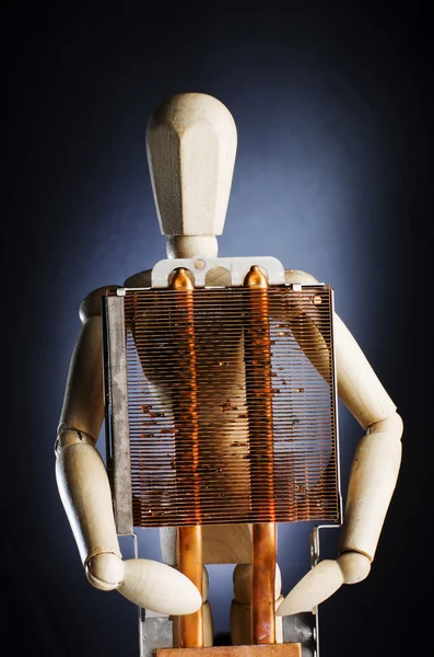 Wooden figure holding dirty computer part on his chest. Do not smoke concept. — 图库照片