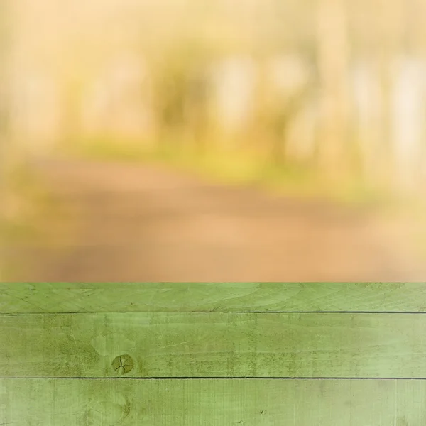 Empty perspective green wood over blurred trees with bokeh background, for product display montage — Stock Photo, Image