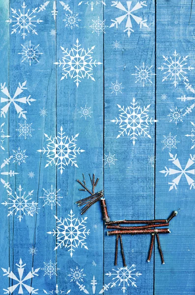 Renar från torra pinnar på trä, blå bakgrund. Snow flaks bild, prydnad, hantverk. — Stockfoto