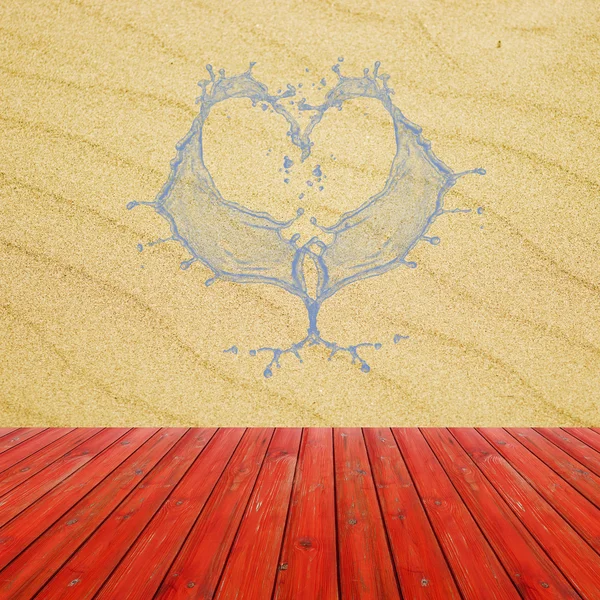 Texture of sand beach background with water splash in heart-shaped. Red table ready for product display montage. — Stock Photo, Image