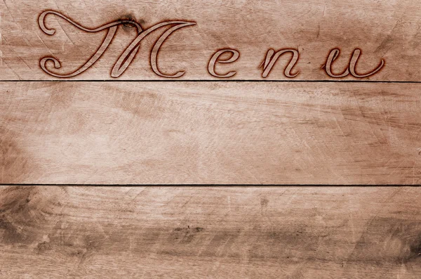 Word menu written, burned lettering on wooden brown background. — Stock Photo, Image