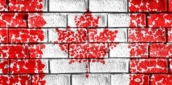 Flag of Canada painted from maple leaf onto a grunge brick wall. — Zdjęcie stockowe