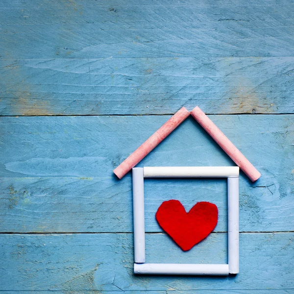 Casa in gesso con cuore rosso in esso su sfondo di legno blu. Concetto dolce casa. Ipoteca — Foto Stock