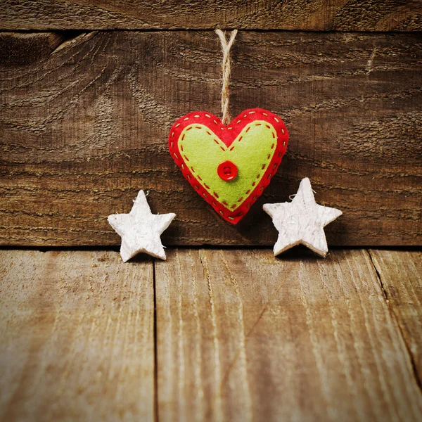 Handmade from felt heart, white stars on wooden background with — Stock Photo, Image