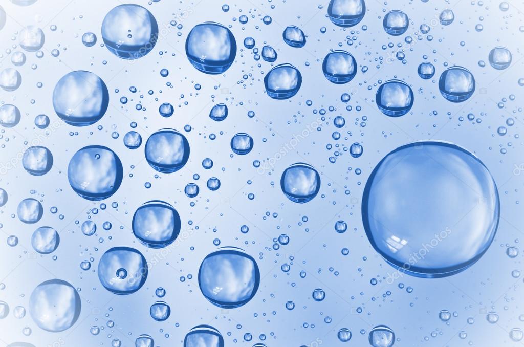 Background of water drops on glass. Water droplets on glass with blue background.