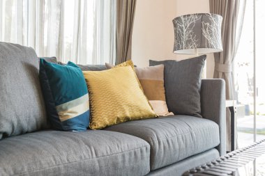 oturma odasında modern gri kanepe üzerinde renkli yastıklar