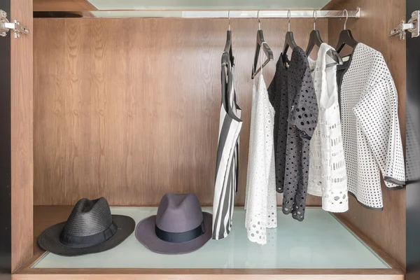 Shirts and suite hanging on rail in wooden wardrobe — Stock Photo, Image