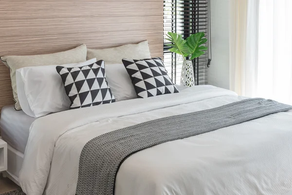 black and white pillows on bed in modern bedroom