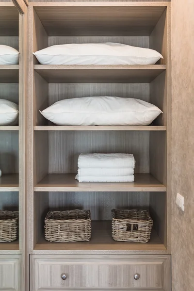 White towel and white pillow in wooden wardrobe with basket — स्टॉक फ़ोटो, इमेज