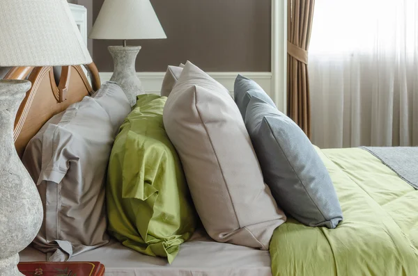 Row of pillows on bed in classic bedroom — Stock Photo, Image