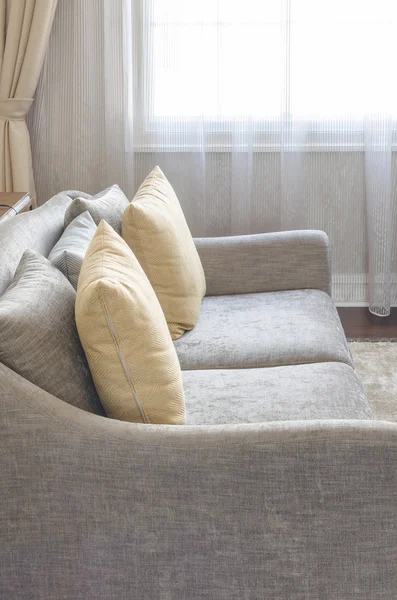 yellow pillow on modern grey sofa in living room