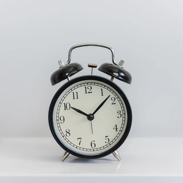 Modern black alarm clock on white — Stock Photo, Image