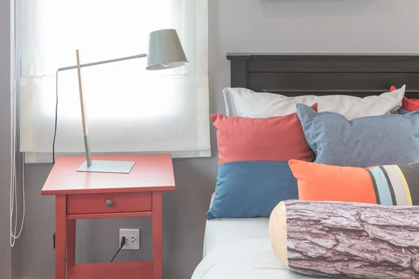 Almohadas de colores en la cama en el diseño de un dormitorio individual — Foto de Stock