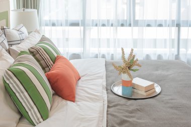 modern yatak odası tasarımı beyaz yatakta renkli yastıklar 