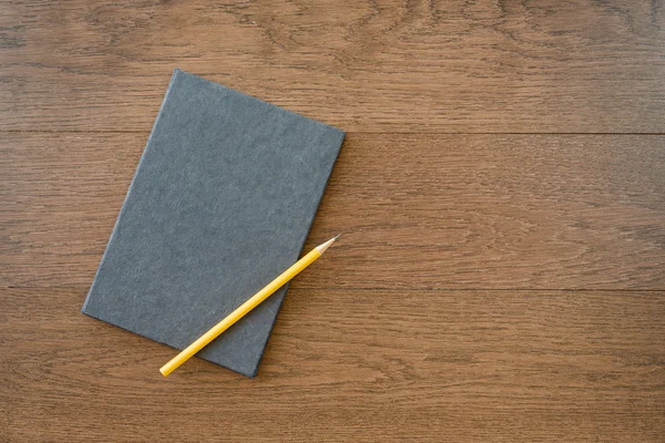 Notebook with pencil on office wooden table Royalty Free Stock Photos